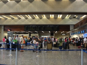 line of people waiting in airport lobby